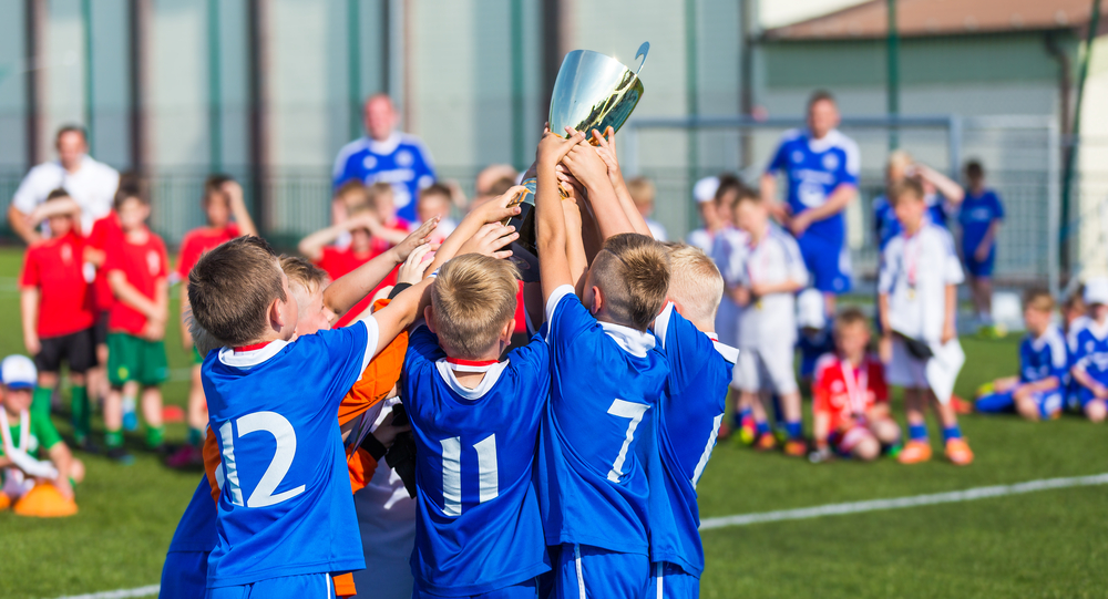 Young,Soccer,Players,Holding,Trophy.,Boys,Celebrating,Soccer,Football,Championship. Ramadan fasting in women's soccer